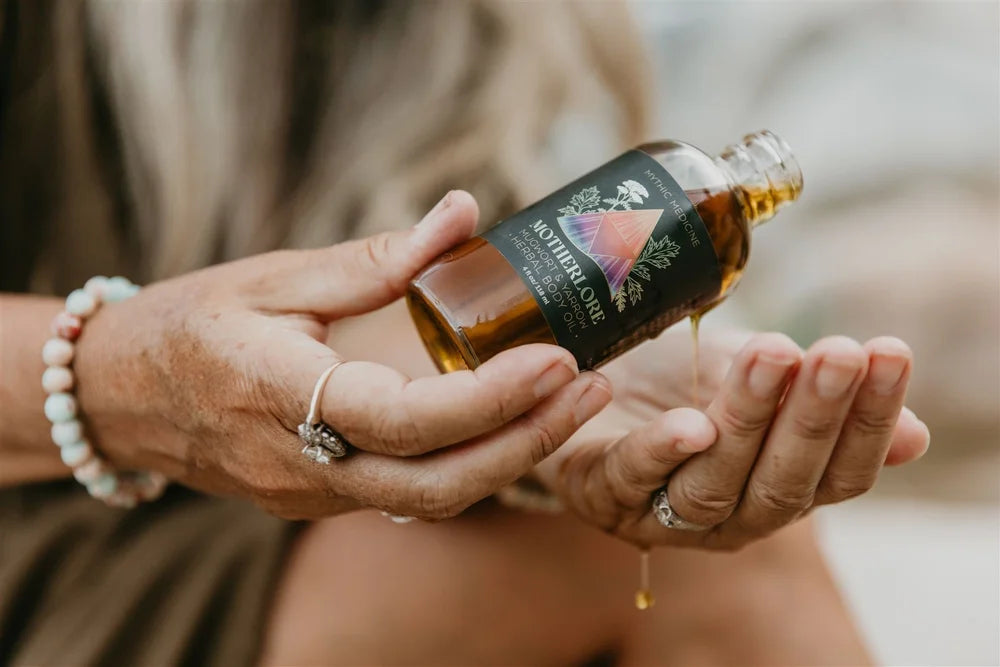 Woman holding a bottle of Motherlore with a blurred background