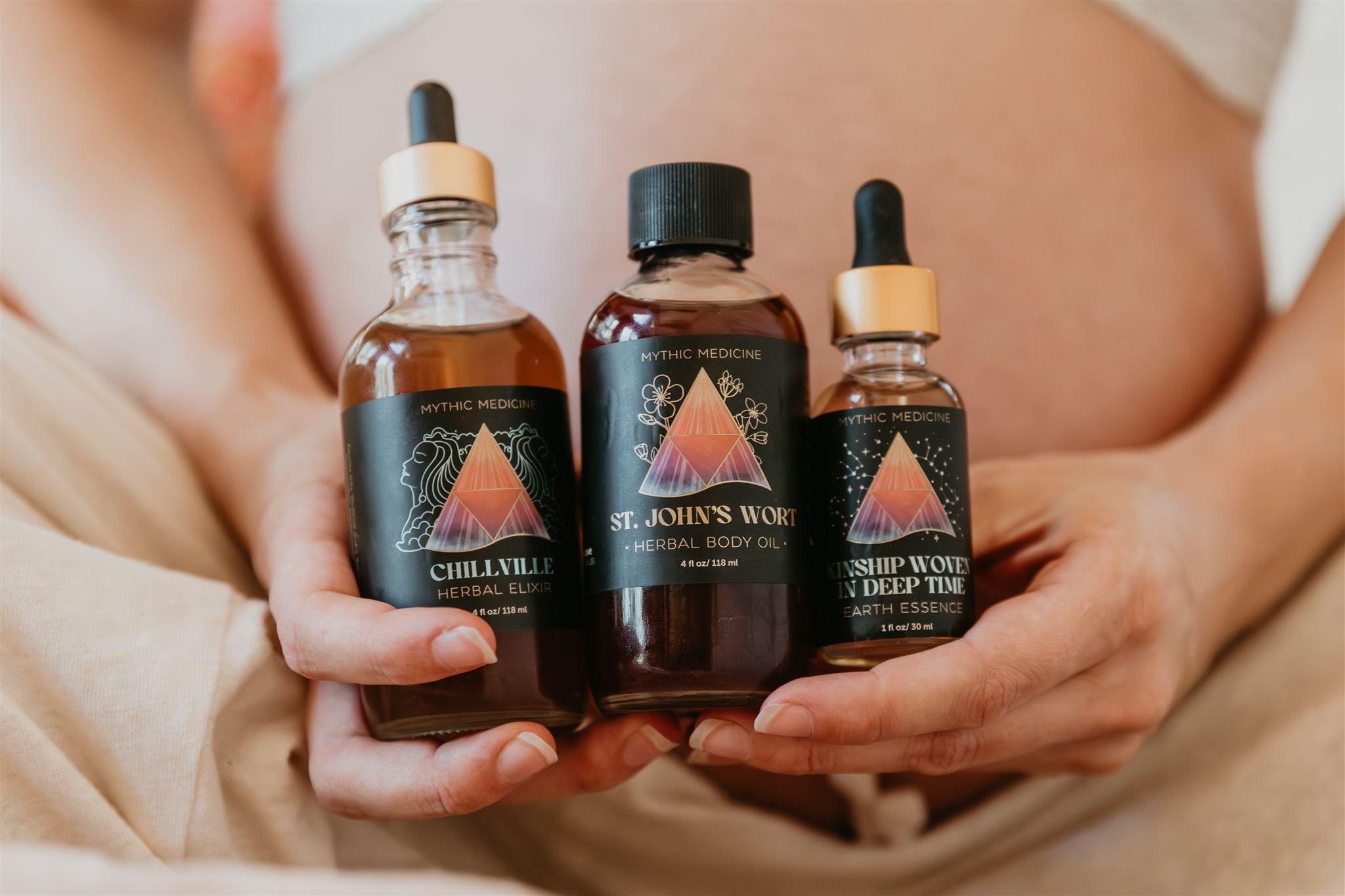 Three bottles of St. John's Wort products held by a woman.